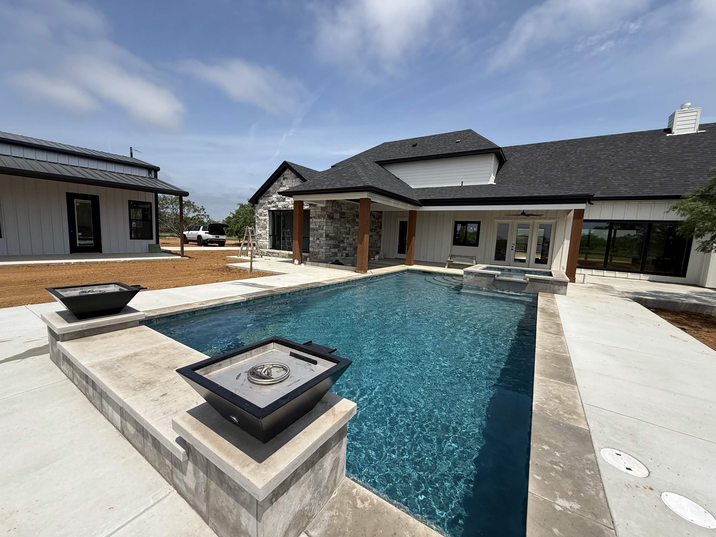 Custom pool deck with built-in fire pits