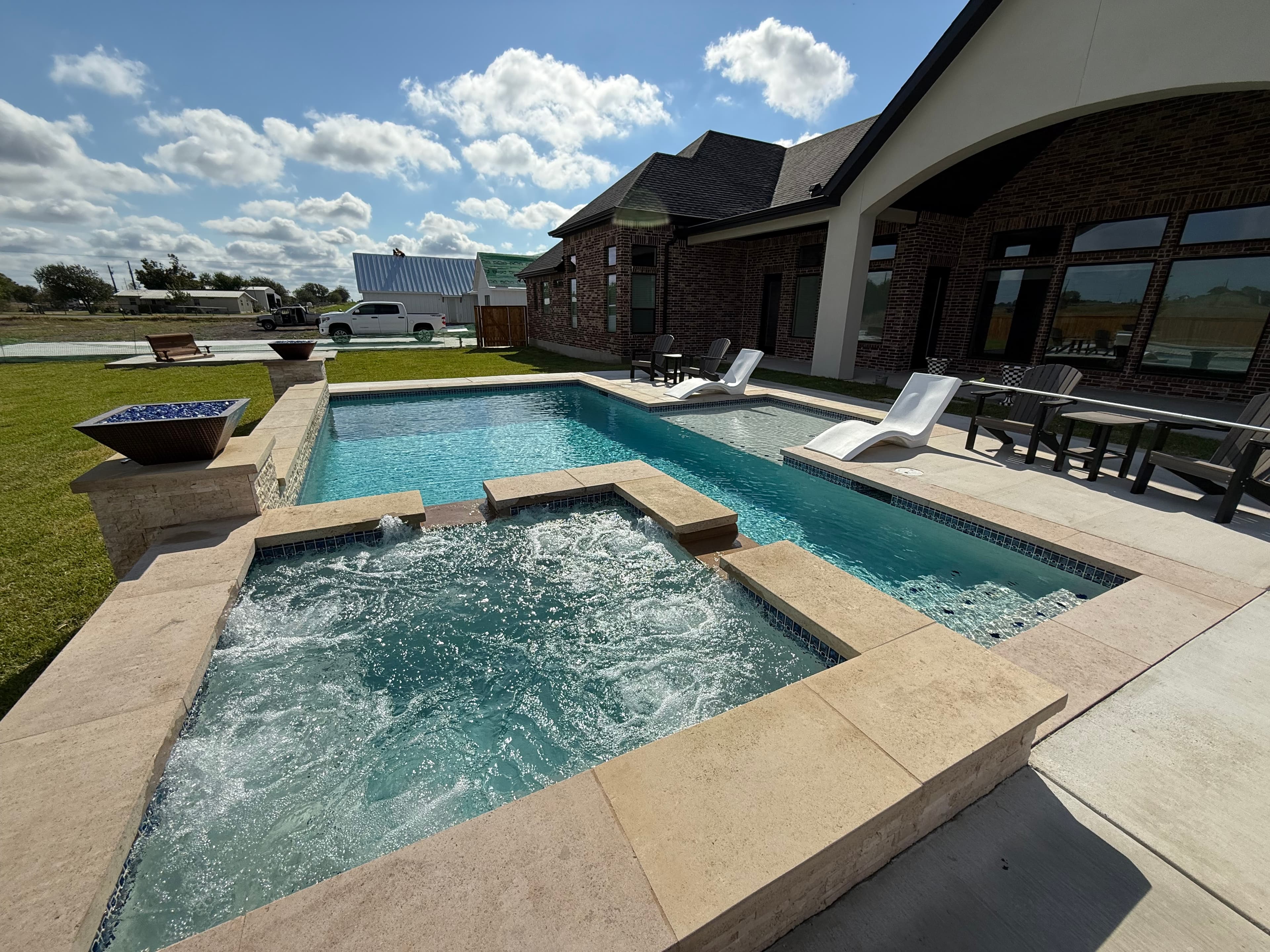 A finished custom pool and spa at dusk in the Texas Hill Country