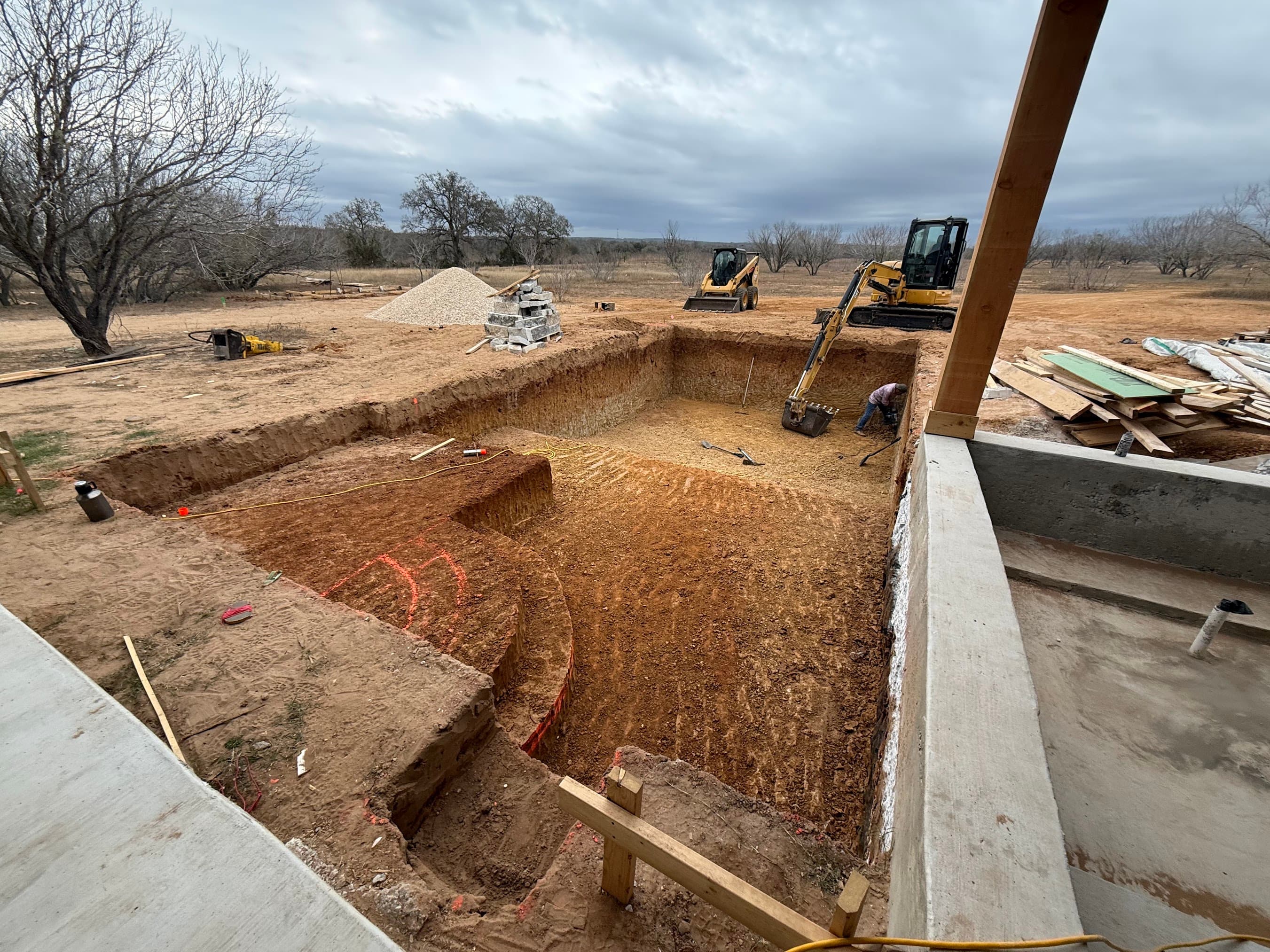 Excavation equipment on site during a new construction pool build