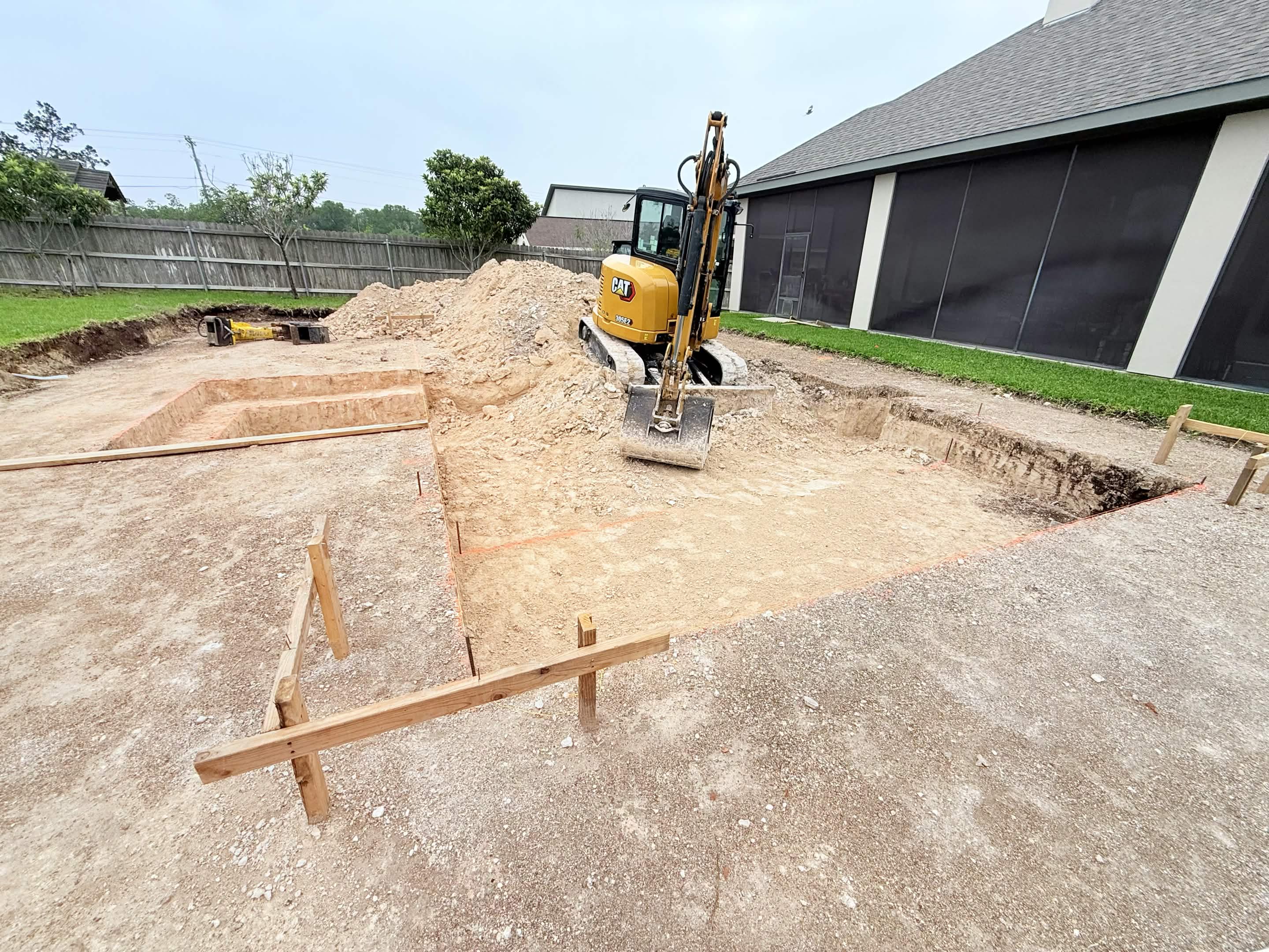 Pool excavation in Seguin — CAT excavator digging through Hill Country dirt
