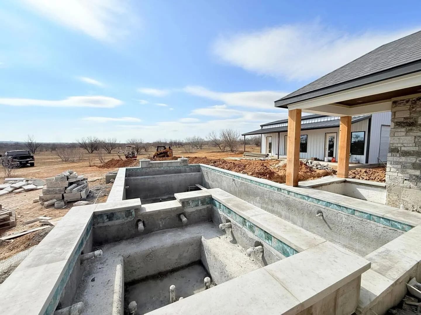 Pool tile and coping installation — craftsmen hand-setting each piece